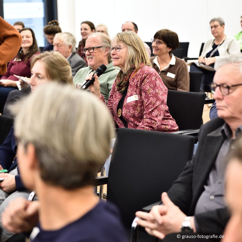 Eine Teilnehmerin hält ein Mikrofon
